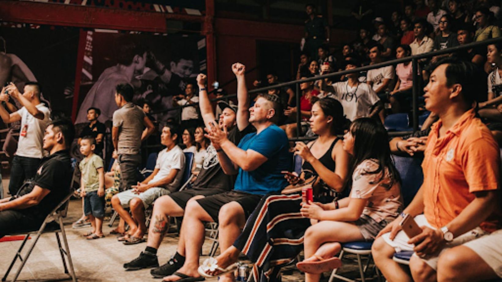 group of people cheering on a sporting event